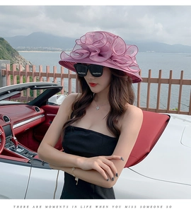 Detail of multi-layered purple organza flower sun hat worn by model in a convertible