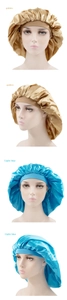 Detail view of large satin sleep caps in golden and light blue on mannequin heads