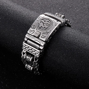 Detailed macro of vintage titanium steel bracelet with engraved mantras and braided chain