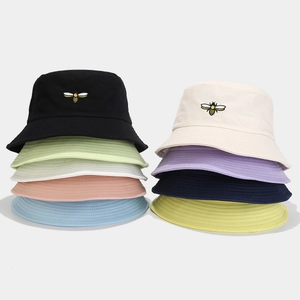 Cotton bucket hat with bee embroidery shown in nine different vibrant summer colors