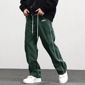 Men's dark green woven joggers with white side stripes and drawstring waist