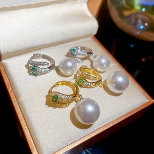 Close-up of 14K gold plated snake earrings with zircon pavé and white round pearls