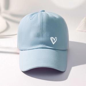 Close-up of light blue cotton baseball cap with white double heart embroidery detail