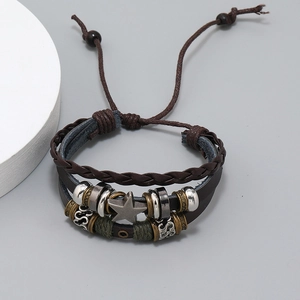 Detail of vintage multilayer leather bracelet with star pendant and woven beads texture