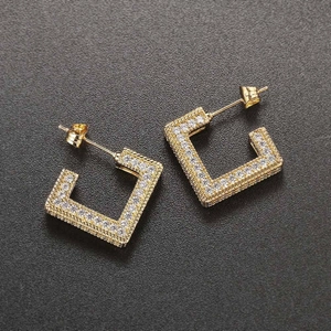Macro shot of gold square pave earrings featuring micro-set white cubic zirconia stones