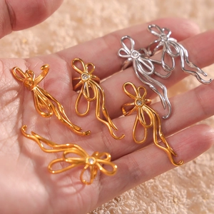 U-shaped stainless steel bow earrings with zircon stones in gold and silver finishes