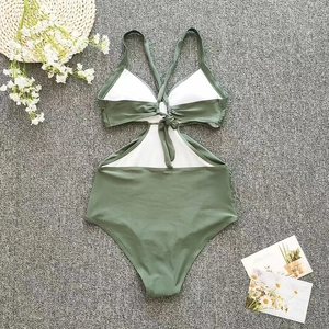 Detailed flat lay of olive green one-piece swimsuit with cutout and lace-up back detail