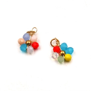 Detail of DIY golden stainless steel pendants with colorful handmade woven beads