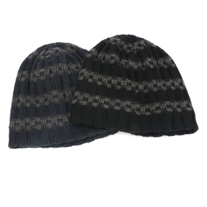 Close-up showing the knit texture and striped patterns of navy and black winter beanies