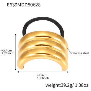 Detail of polished gold stainless steel tiered ponytail holder with black elastic band