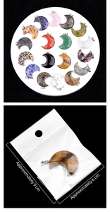 Macro detail of various crescent moon crystal pendants and individual OPP bag packaging