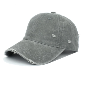 Detail of distressed holes and washed texture on gray vintage cotton baseball cap