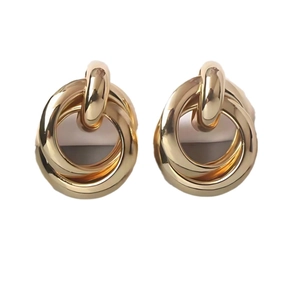 Modern gold interlocking geometric ring earrings with a polished metallic finish