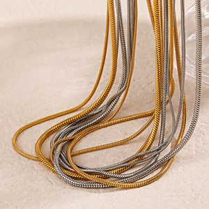 Minimalist gold and silver snake bone chain necklaces in polished stainless steel