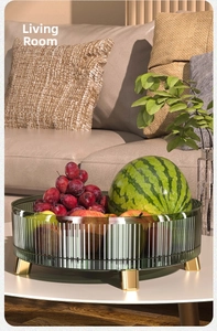Macro shot of green ribbed acrylic fruit bowl with golden legs for desktop storage
