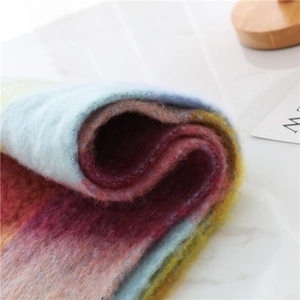 Close-up of thick rainbow plaid scarf featuring soft brushed mohair texture and vibrant colors