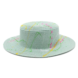 Flat top straw boater hat in light green with colorful artistic graffiti spray paint
