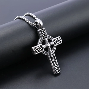 Macro view of stainless steel Viking cross pendant with Celtic knot on a display stand