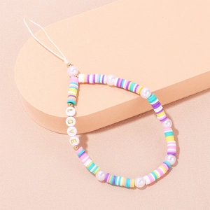 Rainbow polymer clay Evil Eye phone strap with pearls and LOVE charms on beige stand