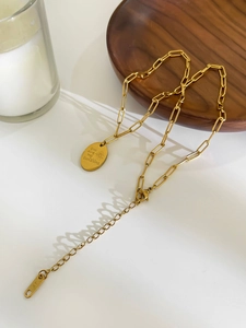 Detail of 18K gold sunshine pendant necklace with lobster clasp and extension chain