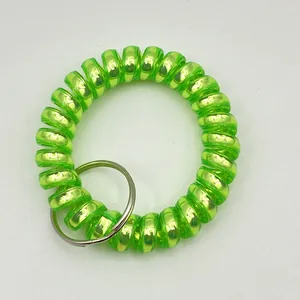 Detailed macro of fluorescent green spiral plastic wristband with metal key ring loop