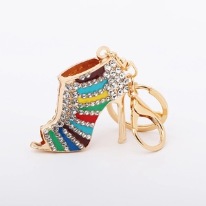 Macro detail of high heel keychain with colorful enamel stripes and sparkling rhinestones