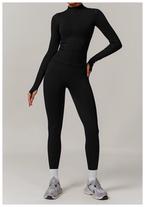 Detail of black seamless yoga set featuring zip-up jacket with thumbholes and leggings