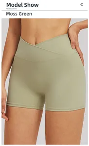 Detail of high-waisted yoga shorts in moss green featuring a cross-waist V-cut design