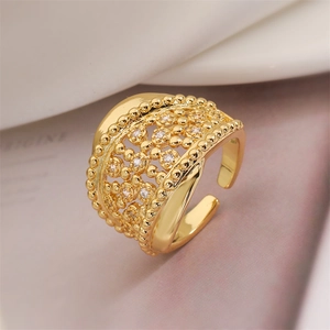 Detail of wide open ring with gold hollow design and rows of sparkling zircons