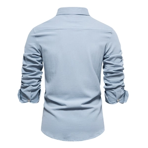Detail view of the back construction and cotton texture of a light blue long-sleeved shirt
