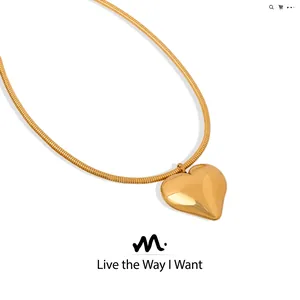 Macro view of gold plated heart pendant with glossy snake chain minimalist jewelry