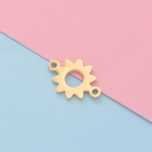Detailed close-up of golden sun-shaped metal connector pendant with dual link holes