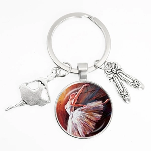 Elegant ballet dancer keychain with artistic glass dome and metal slippers pendants