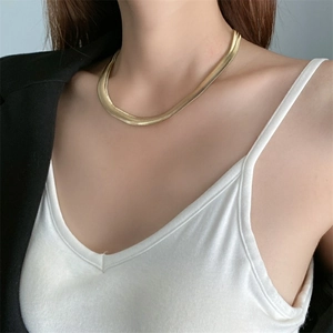 Chic gold-toned titanium steel snake bone chain necklace for women on a model