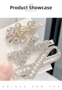 Detail view of bow hair clips with crystal rhinestones and pearls on alloy base