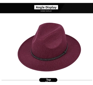 Top view of a burgundy wool fedora hat with a black strap featuring silver metal rivets