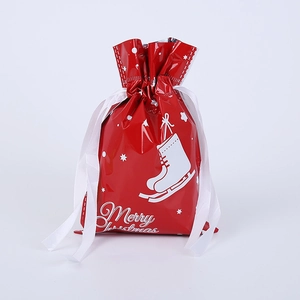 Detail of red Merry Christmas drawstring gift bag with white satin ribbon and skates pattern
