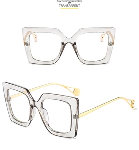 Detail view of square grey glasses with gold metal temples and pearl accents