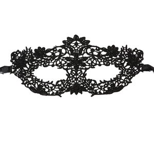 Close-up of black lace eye mask with intricate floral embroidery and satin ribbon ties
