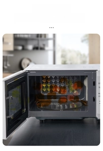 Internal view of a microwave with food splatter stains on the glass plate and walls