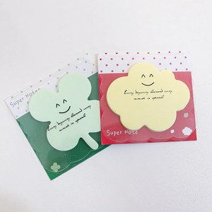 Detail of clover and cloud sticky notes with smiley faces and motivational quotes