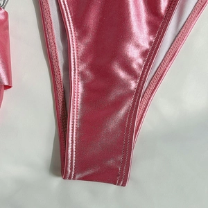Macro detail of glossy pink metallic bikini fabric with fine double-stitch sewing