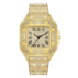 Detail of gold quartz watch with rhinestone bezel and roman numerals on gold dial