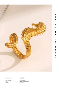 Detailed view of creative seahorse ring in bright gold finish with brand concept typography