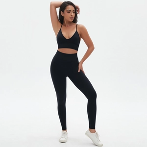Detail view of seamless black yoga set with high-waisted leggings and v-neck sports bra