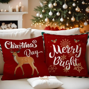 Detail of red Christmas pillow covers featuring reindeer and snowflake prints on linen fabric