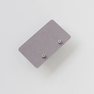 Detailed close-up of aurora round stud earrings with silver-toned four-prong settings