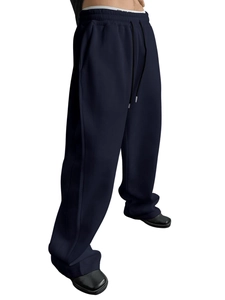 Detail of navy blue relaxed fit sweatpants with elastic drawstring waist and knit fabric