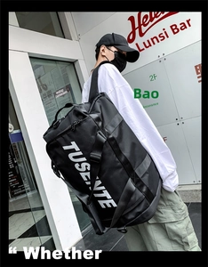 Close-up of large capacity black nylon travel bag featuring the white TUSENTE brand logo