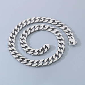 Macro shot of 15mm silver stainless steel Cuban link chain with secure buckle closure